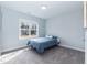 Well-lit bedroom with a large window and plush carpeting, creating a comfortable and inviting atmosphere at 76 Freewill Pl, Raleigh, NC 27603