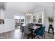 Dining area features a modern chandelier, table with seating for six, and sliding glass door to patio at 76 Freewill Pl, Raleigh, NC 27603