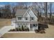Charming two-story home featuring a welcoming front porch and well-maintained landscaping at 76 Freewill Pl, Raleigh, NC 27603