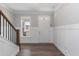 Bright entryway boasting hardwood floors, decorative wainscoting, and a view of the front yard at 76 Freewill Pl, Raleigh, NC 27603