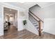 Elegant foyer featuring hardwood floors, stylish staircase, and designer wall decor at 76 Freewill Pl, Raleigh, NC 27603