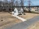 An aerial view of the home highlights the manicured lawn, driveway, and attractive landscaping at 76 Freewill Pl, Raleigh, NC 27603