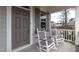 Inviting front porch with gray rocking chairs, perfect for relaxing and enjoying the outdoors at 76 Freewill Pl, Raleigh, NC 27603