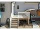 Hot tub deck with stairs and hot tub under awning, and light gray siding at 76 Freewill Pl, Raleigh, NC 27603