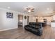 Open concept living space with dark sofa, wood-look floors, and connecting views to the kitchen at 76 Freewill Pl, Raleigh, NC 27603