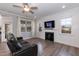 Inviting living room with dark sofa, decorative fireplace, large windows, and wood-look floors at 76 Freewill Pl, Raleigh, NC 27603
