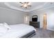 Spacious main bedroom boasts a tray ceiling, ceiling fan, two windows, and ensuite access at 76 Freewill Pl, Raleigh, NC 27603