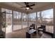 Relaxing screened-in porch with ceiling fan and comfortable wicker seating arrangement at 76 Freewill Pl, Raleigh, NC 27603