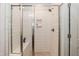 Modern shower featuring subway tile, glass doors, and a built-in niche for storage at 76 Freewill Pl, Raleigh, NC 27603