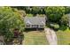 Aerial view of single-Gathering home featuring a well-manicured lawn, driveway, and mature landscaping at 765 S Hollybrook Rd, Wendell, NC 27591