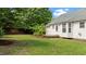 Backyard featuring a small deck, well-kept lawn, and tropical foliage at 765 S Hollybrook Rd, Wendell, NC 27591