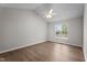 Bright bedroom featuring wood flooring, modern ceiling fan, and window with blinds at 765 S Hollybrook Rd, Wendell, NC 27591