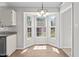 Dining area featuring hardwood flooring, large windows, and a chandelier at 765 S Hollybrook Rd, Wendell, NC 27591