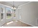 Dining area featuring a chandelier, hardwood flooring, and a large window at 765 S Hollybrook Rd, Wendell, NC 27591