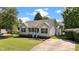 Inviting single-story home with a well-maintained lawn and a long driveway at 765 S Hollybrook Rd, Wendell, NC 27591