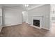View of a living room featuring wood flooring, a ceiling fan, a fireplace, and neutral paint at 765 S Hollybrook Rd, Wendell, NC 27591