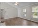 Living room featuring a ceiling fan, wood flooring, neutral paint, and natural lighting at 765 S Hollybrook Rd, Wendell, NC 27591