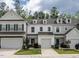 Charming townhome exteriors feature attached garages, landscaped yards, and inviting entryways at 80 Willow Green Dr, Clayton, NC 27527