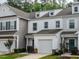 Attractive townhome exterior with a private garage, neat landscaping, and classic design elements at 80 Willow Green Dr, Clayton, NC 27527