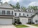 Charming townhome exterior featuring a garage, well-maintained lawn, and appealing architectural details at 80 Willow Green Dr, Clayton, NC 27527