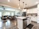 Open-concept kitchen features modern stainless steel appliances, granite counters, and breakfast bar at 80 Willow Green Dr, Clayton, NC 27527