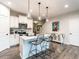 Kitchen features a breakfast bar, white cabinetry, granite countertop, and modern pendant lighting at 80 Willow Green Dr, Clayton, NC 27527