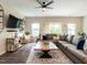 Spacious living room featuring a large sectional sofa, area rug, and contemporary decor at 80 Willow Green Dr, Clayton, NC 27527