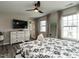 Bright main bedroom with large windows, wood flooring, and a contemporary ceiling fan at 80 Willow Green Dr, Clayton, NC 27527