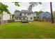 Expansive backyard with wooden deck, privacy fence, and lush lawn at 805 Penncross Dr, Raleigh, NC 27610