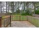 Wooden deck overlooking a spacious backyard surrounded by mature trees and a privacy fence at 805 Penncross Dr, Raleigh, NC 27610