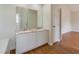 Bathroom featuring double sink vanity with granite countertops and wood-look floor at 805 Penncross Dr, Raleigh, NC 27610