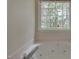 Modern bathtub with jets and a large window overlooking the trees at 805 Penncross Dr, Raleigh, NC 27610