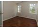 Bedroom featuring hardwood floors, and two windows offering a view of the outdoors at 805 Penncross Dr, Raleigh, NC 27610