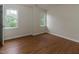 Bright bedroom with natural light from windows, light walls, and hardwood floors at 805 Penncross Dr, Raleigh, NC 27610