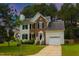 Two-story brick and siding home with manicured lawn and attached garage at 805 Penncross Dr, Raleigh, NC 27610