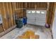 Spacious unfinished garage with wooden walls, storage, and overhead door at 805 Penncross Dr, Raleigh, NC 27610