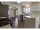 Well-lit kitchen with white cabinets, stainless steel appliances, and wood-look flooring, leading to a dining area at 805 Penncross Dr, Raleigh, NC 27610