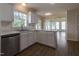 Bright kitchen featuring white cabinetry, stainless steel dishwasher, and durable wood-look flooring at 805 Penncross Dr, Raleigh, NC 27610