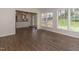 Bright living room featuring wood floors and large windows offering a view of the outdoors at 805 Penncross Dr, Raleigh, NC 27610