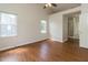 Spacious main bedroom featuring hardwood floors, ceiling fan, and an ensuite bathroom at 805 Penncross Dr, Raleigh, NC 27610