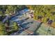 Aerial view of tennis courts, pool, and club house surrounded by mature trees at 81502 Alexander, Chapel Hill, NC 27517