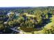 Expansive aerial view of golf course homes surrounded by lush greenery, lakes, and fairways at 81502 Alexander, Chapel Hill, NC 27517