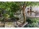 Tranquil backyard featuring a stone patio, lush trees, and a screened porch for relaxation at 81502 Alexander, Chapel Hill, NC 27517