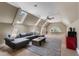 Large bonus room with skylights, a ceiling fan, carpet, and a comfortable couch at 81502 Alexander, Chapel Hill, NC 27517