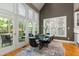 Elegant dining area with soaring ceilings, tall windows, chic lighting, and seating for six guests at 81502 Alexander, Chapel Hill, NC 27517
