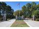 Scenic Governors Club entrance with stone pillars, manicured landscaping, and American flag at 81502 Alexander, Chapel Hill, NC 27517
