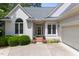 Close up of front of home showing a glass front door, potted plants and the two car garage at 81502 Alexander, Chapel Hill, NC 27517