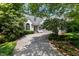 Stunning single-story home with beautiful landscaping and a long driveway shaded by mature trees at 81502 Alexander, Chapel Hill, NC 27517
