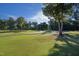 Beautiful golf course view, showcasing a manicured green with mature trees under a clear, sunny sky at 81502 Alexander, Chapel Hill, NC 27517