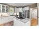 Well-lit kitchen featuring granite counters, an island cooktop, and stainless steel appliances at 81502 Alexander, Chapel Hill, NC 27517